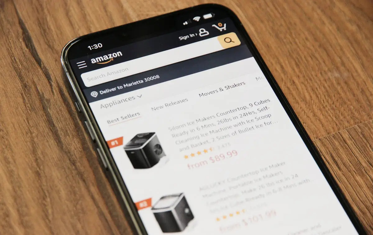 Black smartphone displaying amazon website with ice makers search in article on best global tech stores