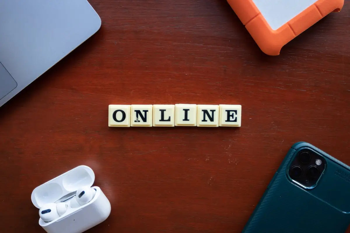 The word online spelled in cream-colored square letter tiles with black letters for affordable fashion and tech delivery.