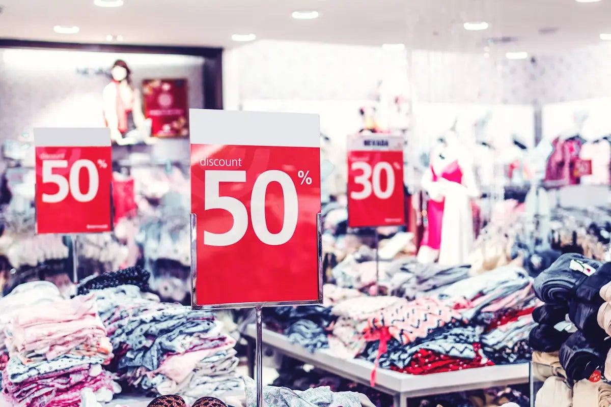 Red rectangular discount sign showing 50% off for tech deals and fast gadget delivery promotions