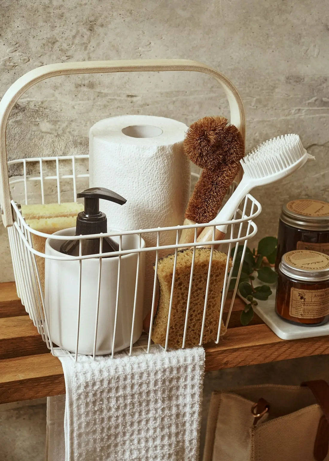 White wire basket with handle holding bathroom essentials featured in fashion clothing and home essentials article