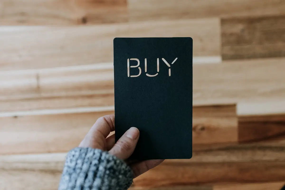 Black rectangular notebook with the word buy in white uppercase letters for shopping trending fashion and electronics online
