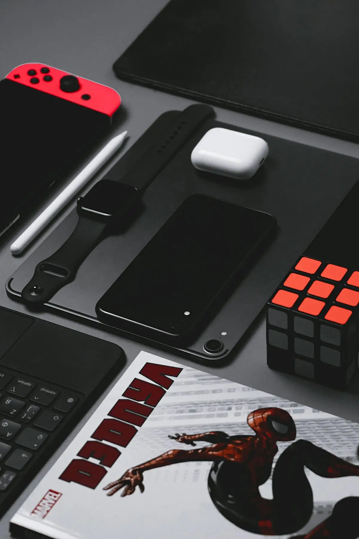 Red nintendo switch console with black joy-con controllers and white stylus illustrating fast delivery tech gadgets guide