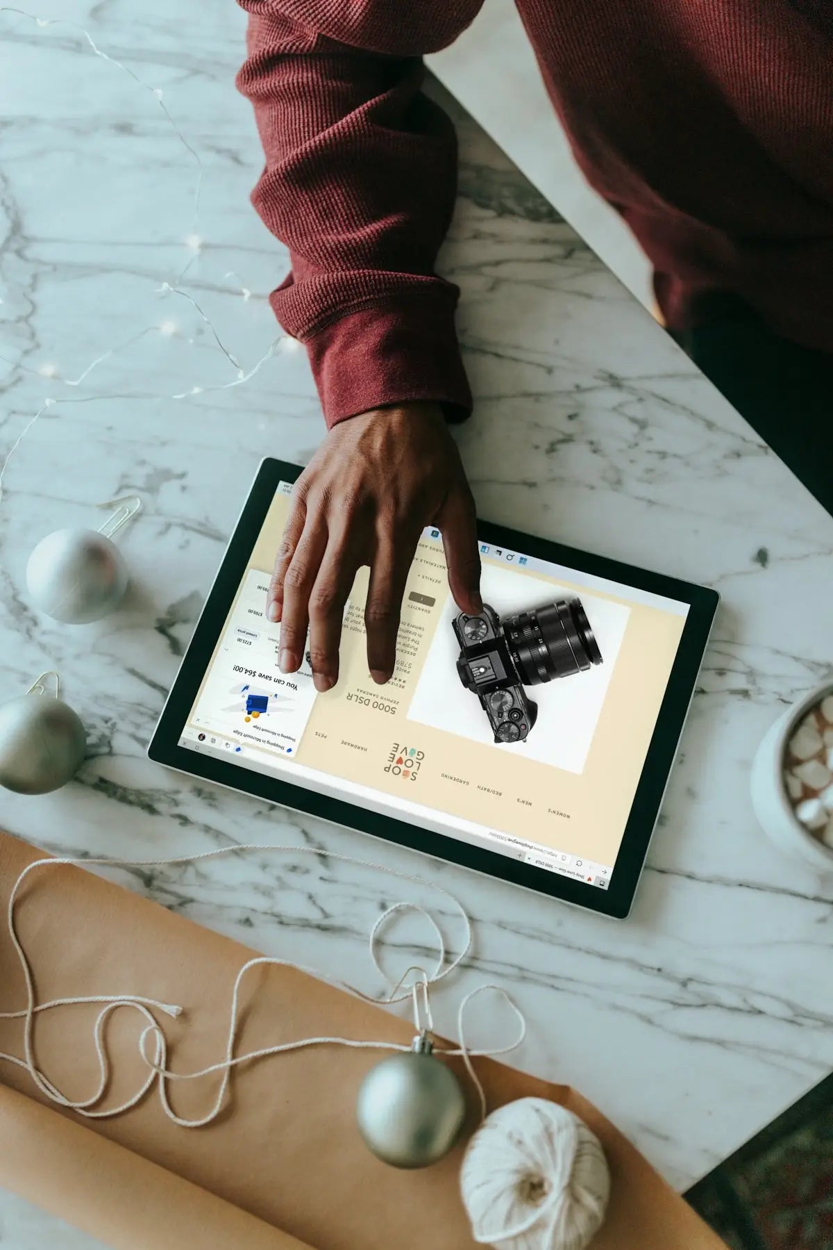 Black digital camera displayed on a tablet screen featuring high-resolution lens for trending tech gadgets and lifestyle essentials