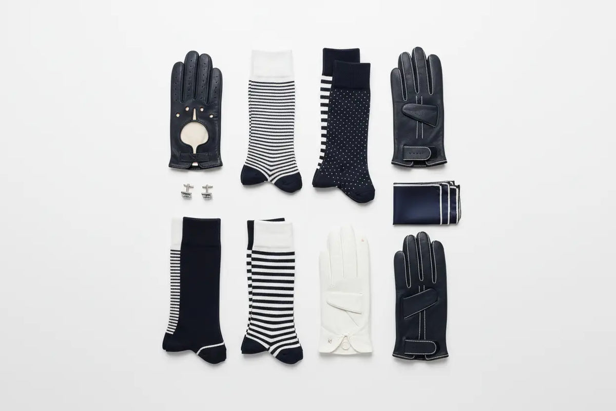 Black leather men’s gloves with white stitching and circular cutout shown from the back in socks and gloves collection