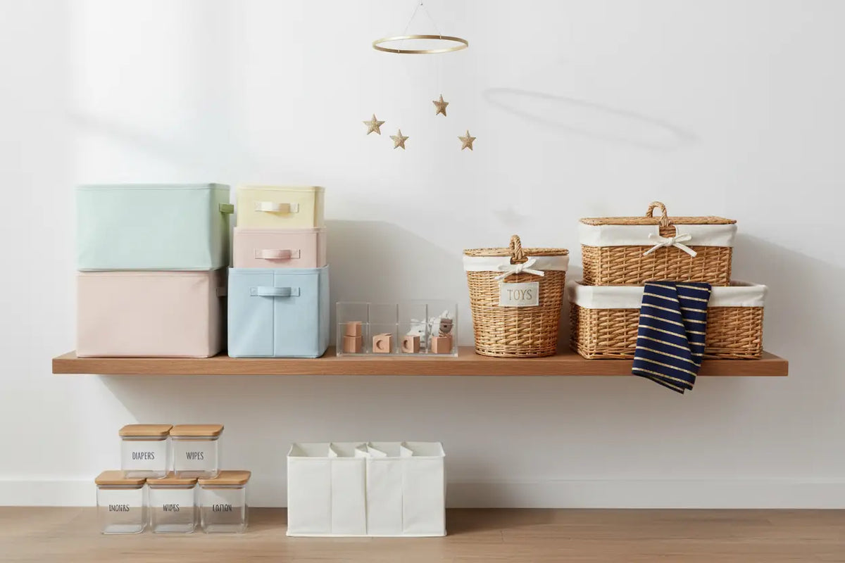 Woven wicker storage baskets with white fabric linings and decorative bows for baby storage and organization.