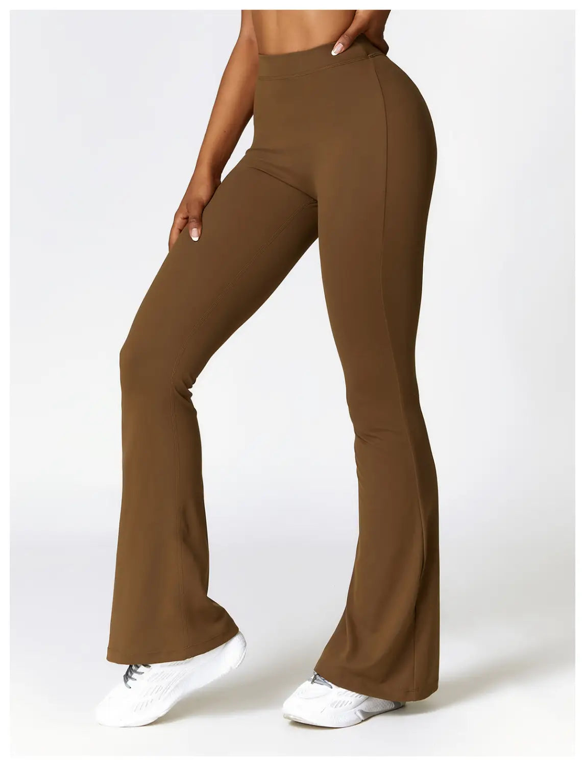 Brown high-waisted flared yoga pants made of smooth stretchy fabric designed as active trousers.