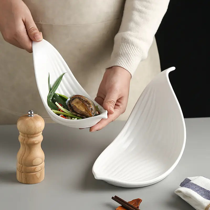 White leaf ceramic plate irregular serving dish with subtle vertical ridges and a smooth white finish.