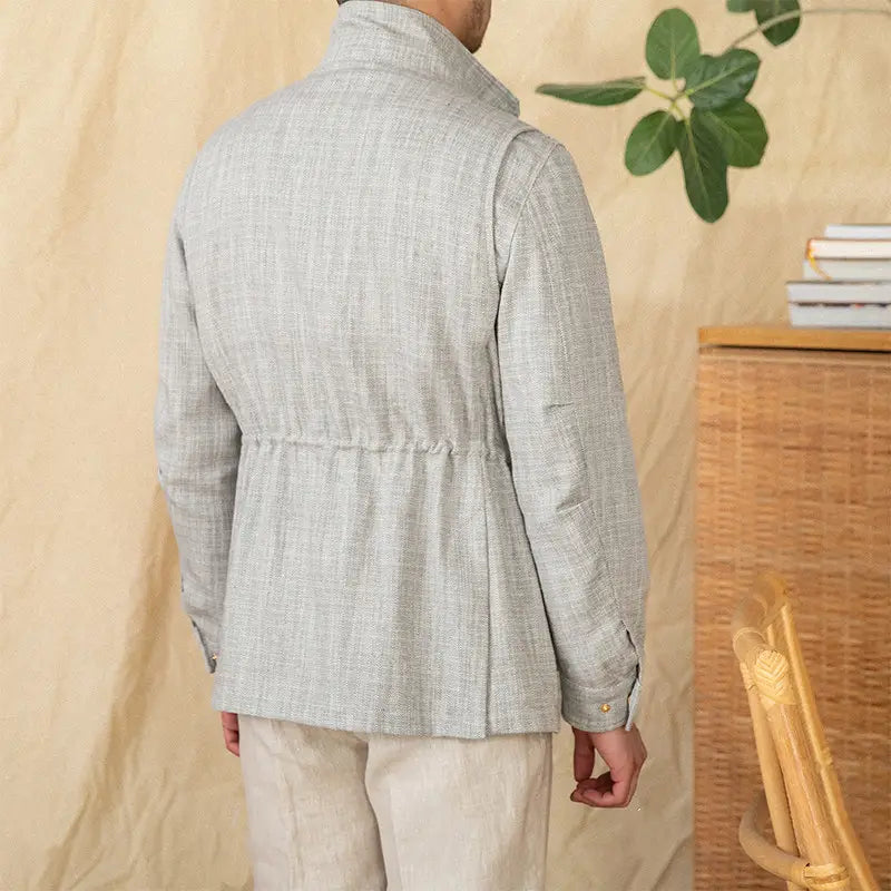Light gray cotton linen m65 safari jacket with textured fabric, structured collar, and subtle pleats at the waist.
