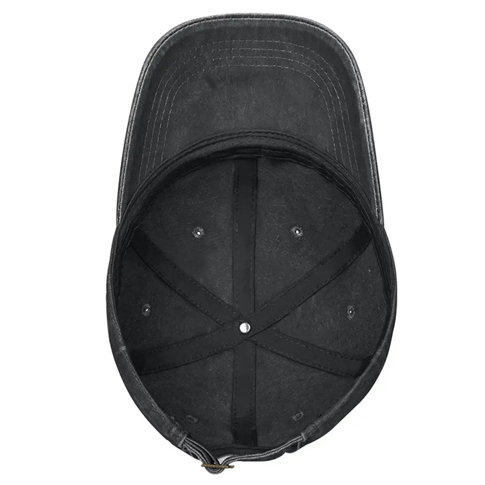 Black denim baseball cap with curved brim and visible stitching featuring Elephant embroidered vintage washed cotton design.