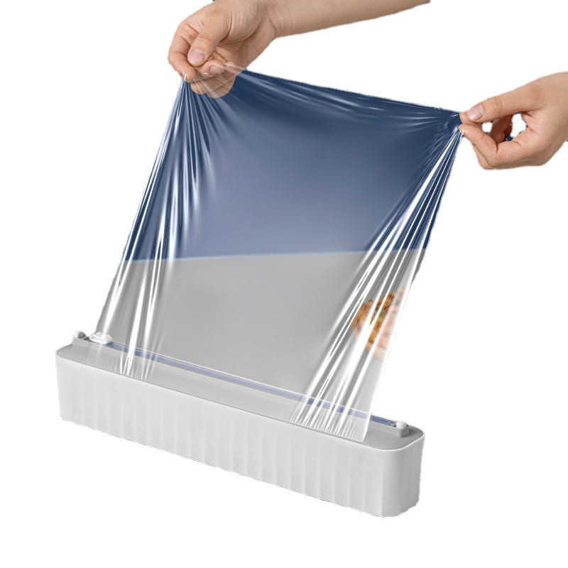 Magnetischer Kunststoff-Folienabschneider und -spender, aus dem blaue Kunststoff-Lebensmittelfolie aus einem weißen Rollenspender gezogen wird
