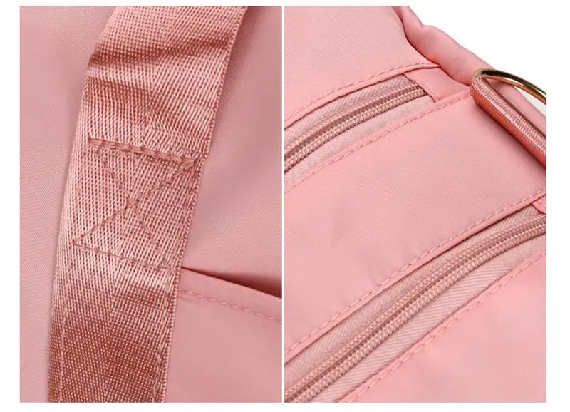 Pink nylon waterproof Oxford travel duffel bag with gold-tone zipper pulls and reinforced strap stitching for gym and sports.