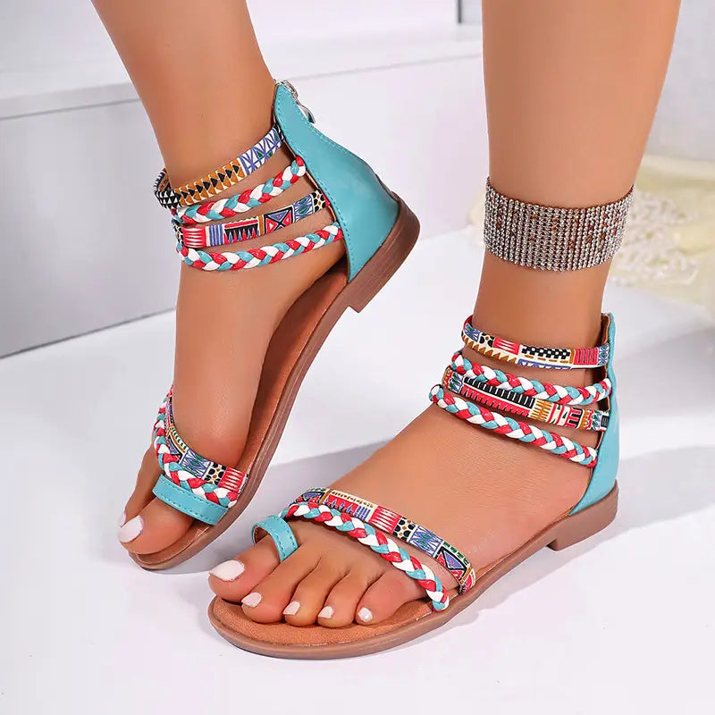 Bohemian ethnic braided ankle strap flat sandals featuring turquoise and brown strappy design with colorful braided geometric patterned ankle straps.