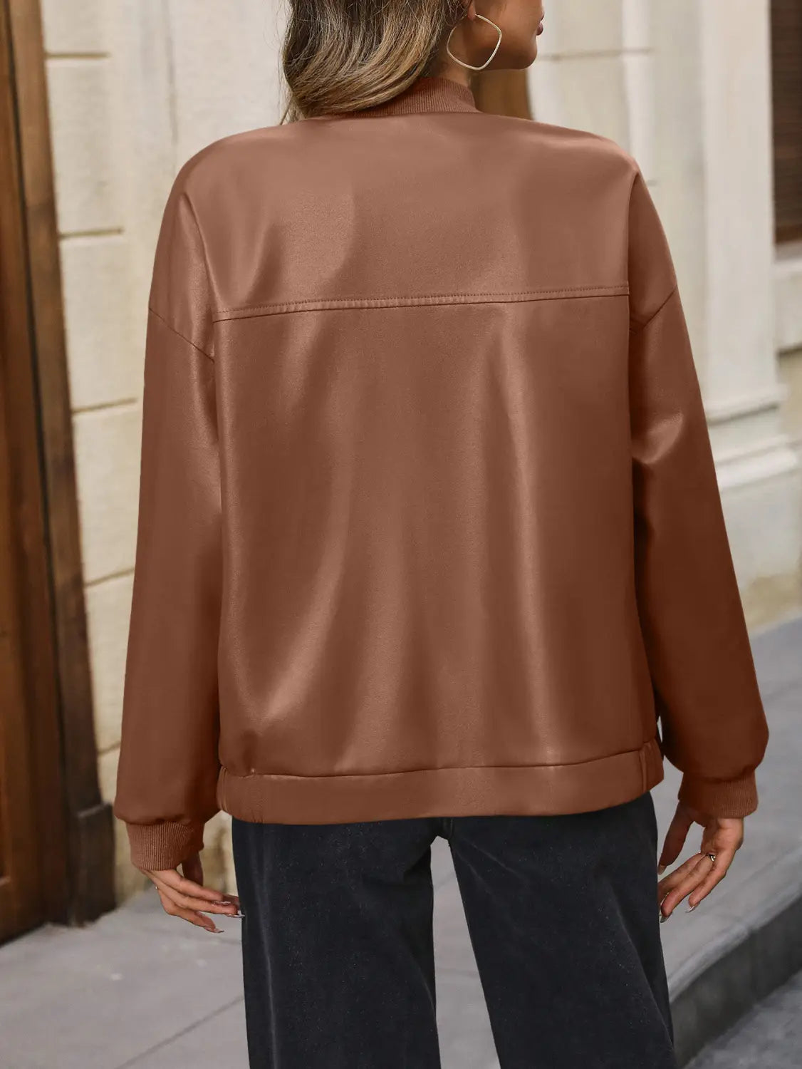 A sleek matte brown faux leather bomber jacket with ribbed cuffs and a relaxed fit.