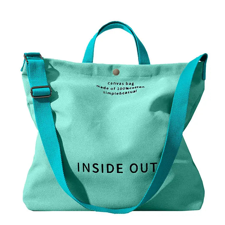 Tan canvas tote bag with high end large capacity black inside out lettering and wooden ring handles.