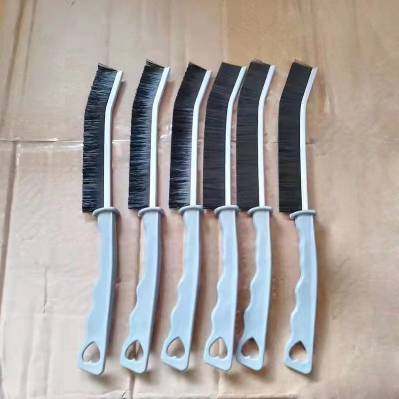 Set of six gray-handled cleaning brushes with black bristles and curved heads designed for tile and crevice gap cleaning.