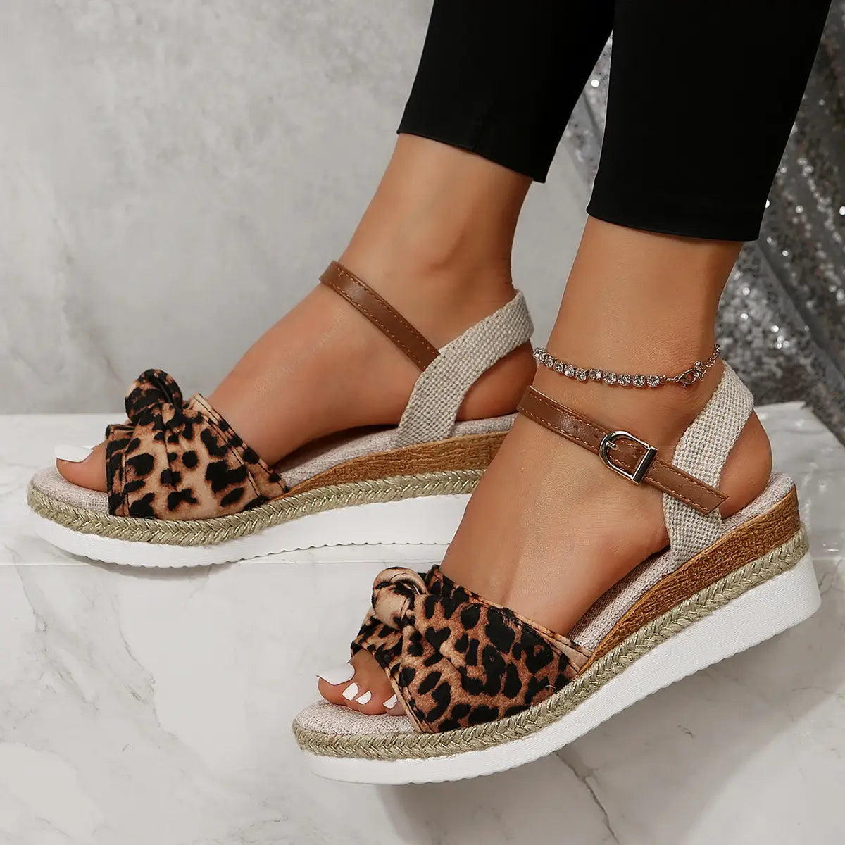 bow wedge sandals featuring leopard print wedge heels with woven rope soles and brown ankle buckle straps