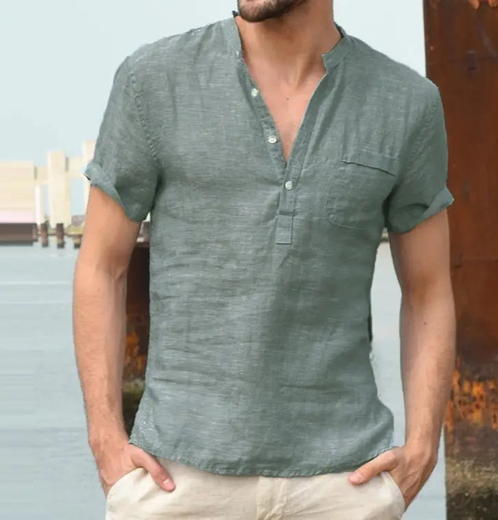 A men’s casual short sleeve linen blend summer shirt in muted green with a button-down front and a single chest pocket.
