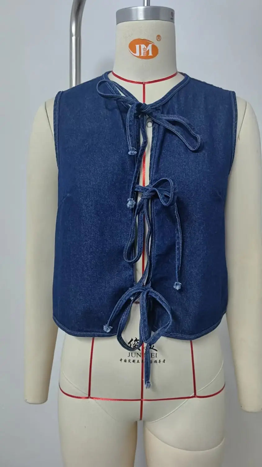 blue denim sleeveless crop top with front bow tie closures in y2k style.