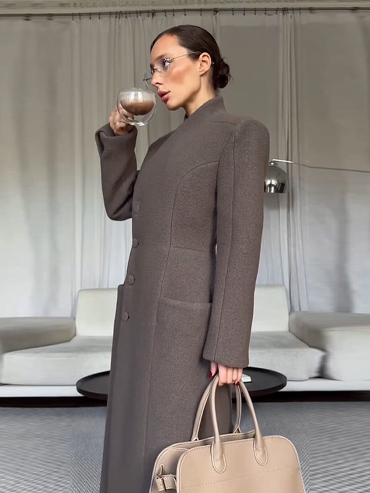 A sleek long taupe wool coat with a structured silhouette and subtle front pockets designed as charcoal gray wool coat women waisted long outerwear.