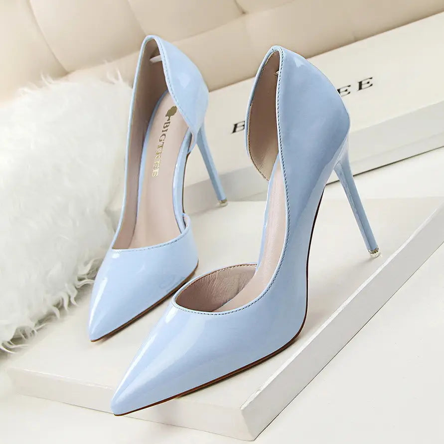 Light blue patent leather pointed toe stiletto high heel pumps with a sleek design and thin heel.