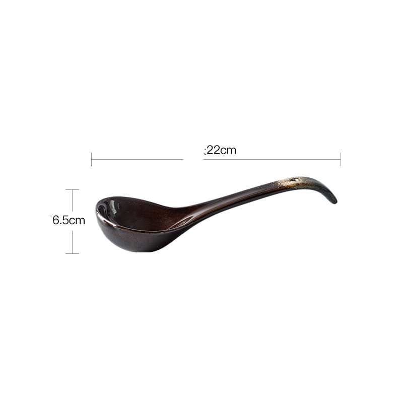 A sleek glossy black ceramic ladle with a gracefully curved handle and subtle gold accents near the tip from a ceramic tableware set black and gold kiln glaze porcelain.