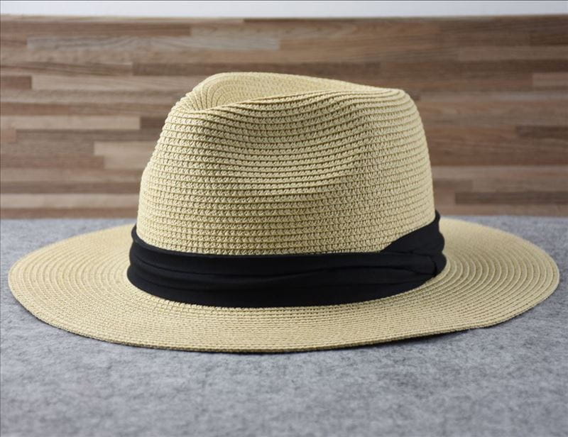 Beige woven straw fedora hat with a black ribbon band designed for foldable sun protection for men.