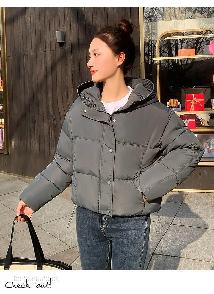 Gray women hooded short down jacket featuring a hood and button closures for winter wear.