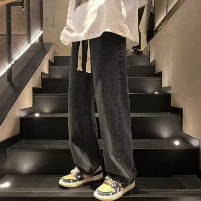 Dark-wash straight-leg denim jeans with a relaxed fit and subtle fading featured alongside corduroy drawstring casual trousers.