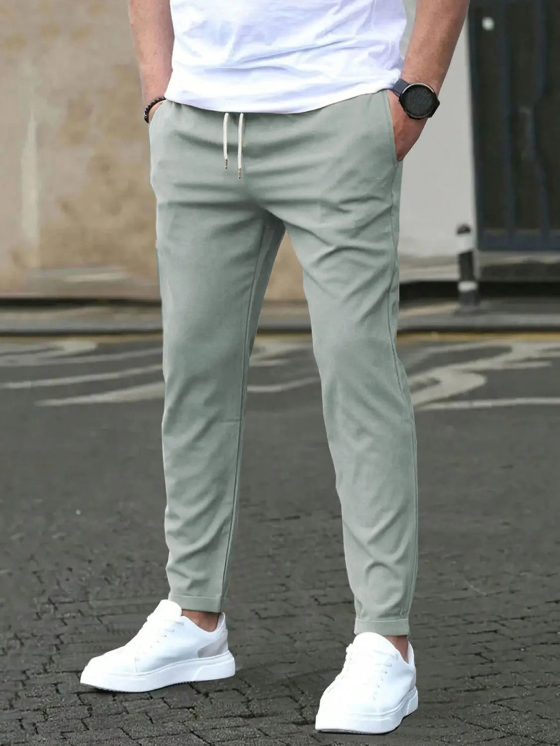 Slim fit tapered jogger pants in light green with white drawstrings designed for comfort and style.