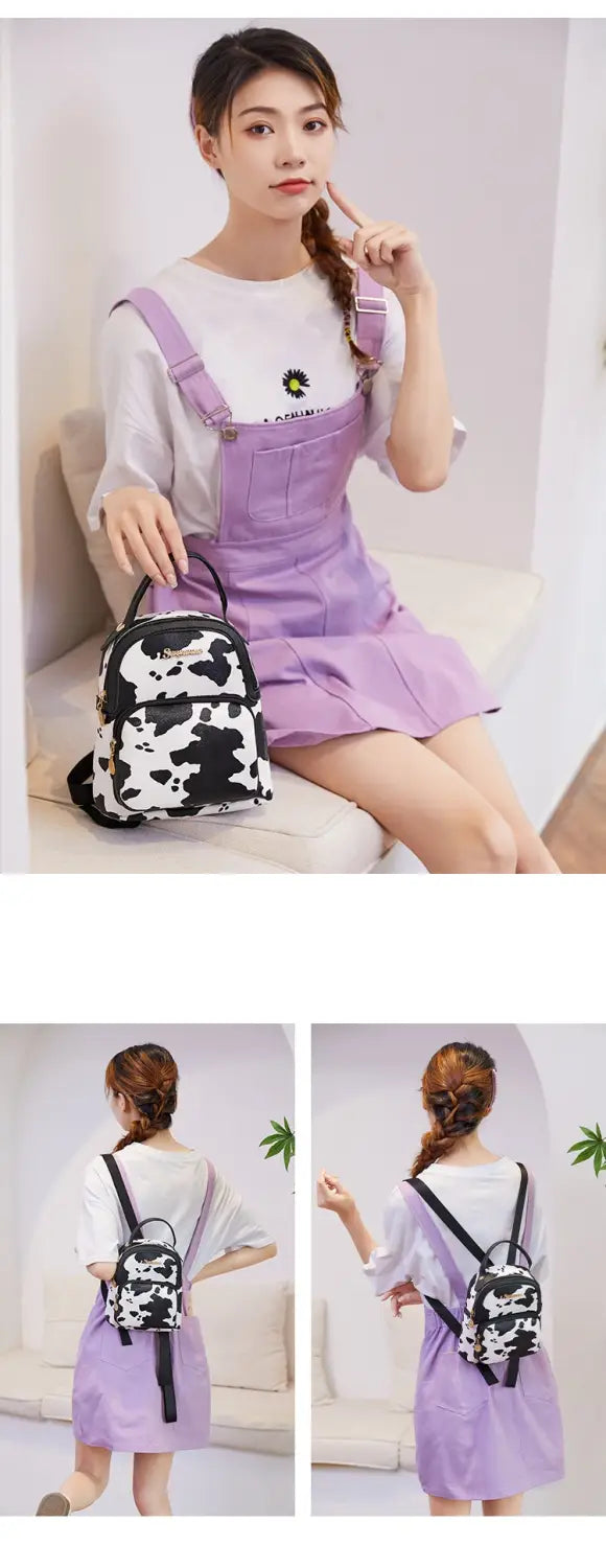 A small black and white cow print mini backpack with adjustable straps in Korean style.
