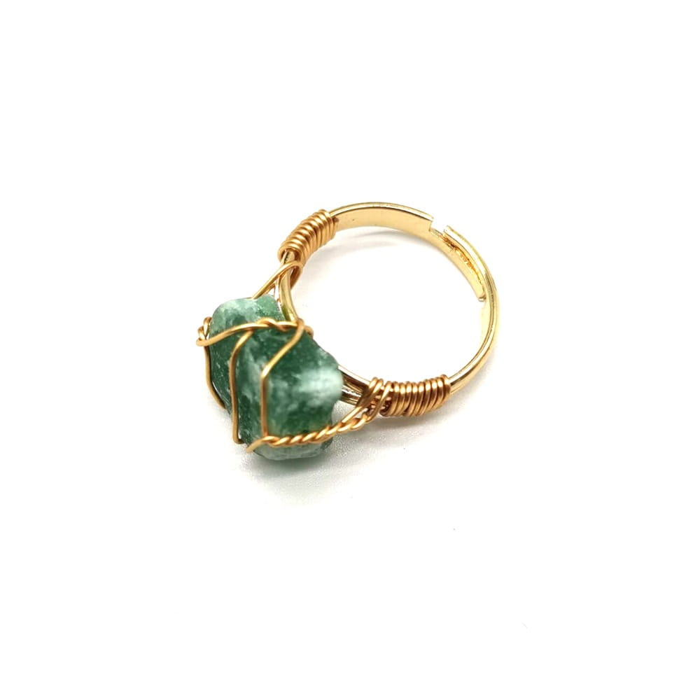 Handcrafted raw gemstone gold wire wrapped adjustable ring featuring a gold wire setting and a raw faceted green gemstone.