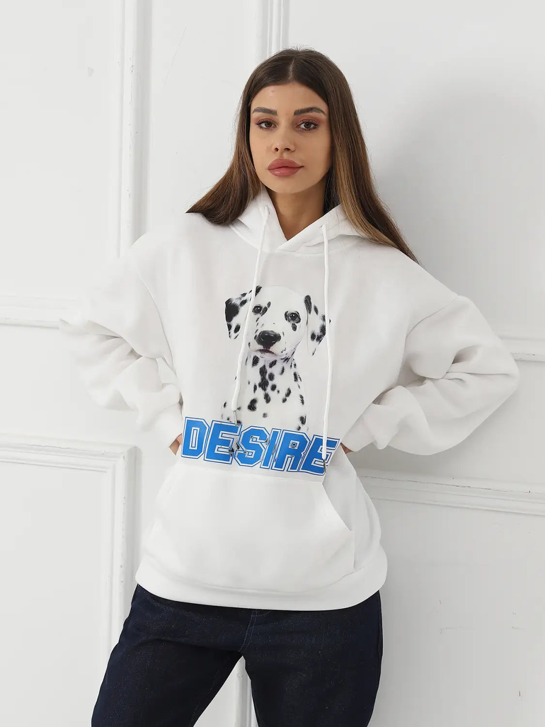 White hoodie featuring a black and white dalmatian graphic and bold blue desire lettering across the chest with a cat ear hood for women.
