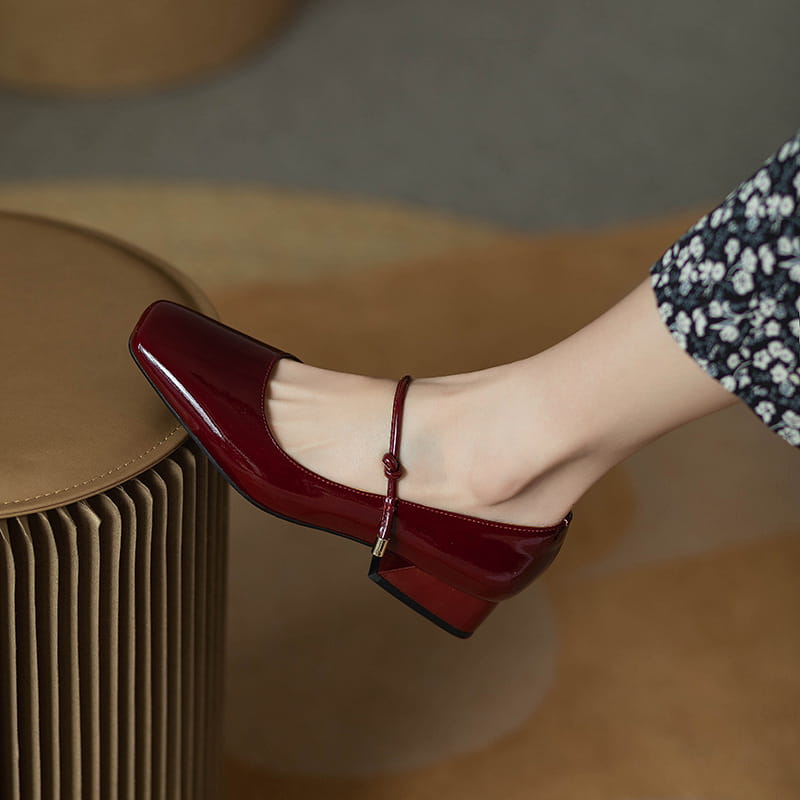 Burgundy patent leather mary jane flats with a square toe and low block heel for elegant everyday wear.