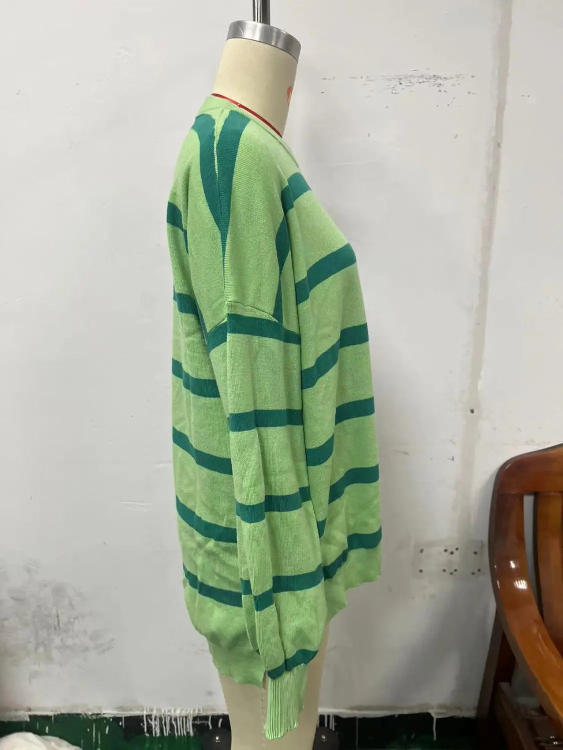 A light green and dark teal horizontally striped oversized split color knit cardigan with ribbed cuffs and hem for women.