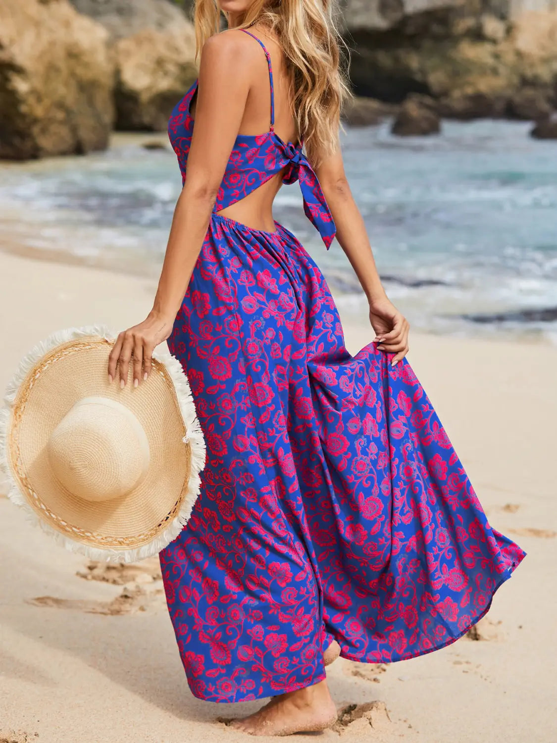 a flowing two-piece beach dress in vibrant purple and magenta floral print with thin spaghetti straps and a back tie detail shown from the back side