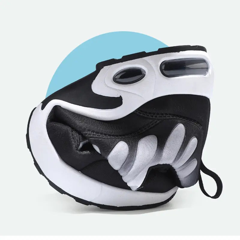 Black and white air cushion running shoes featuring a playful cartoonish face design with exaggerated eyes and tooth-like patterns on the side for fashion and casual wear.