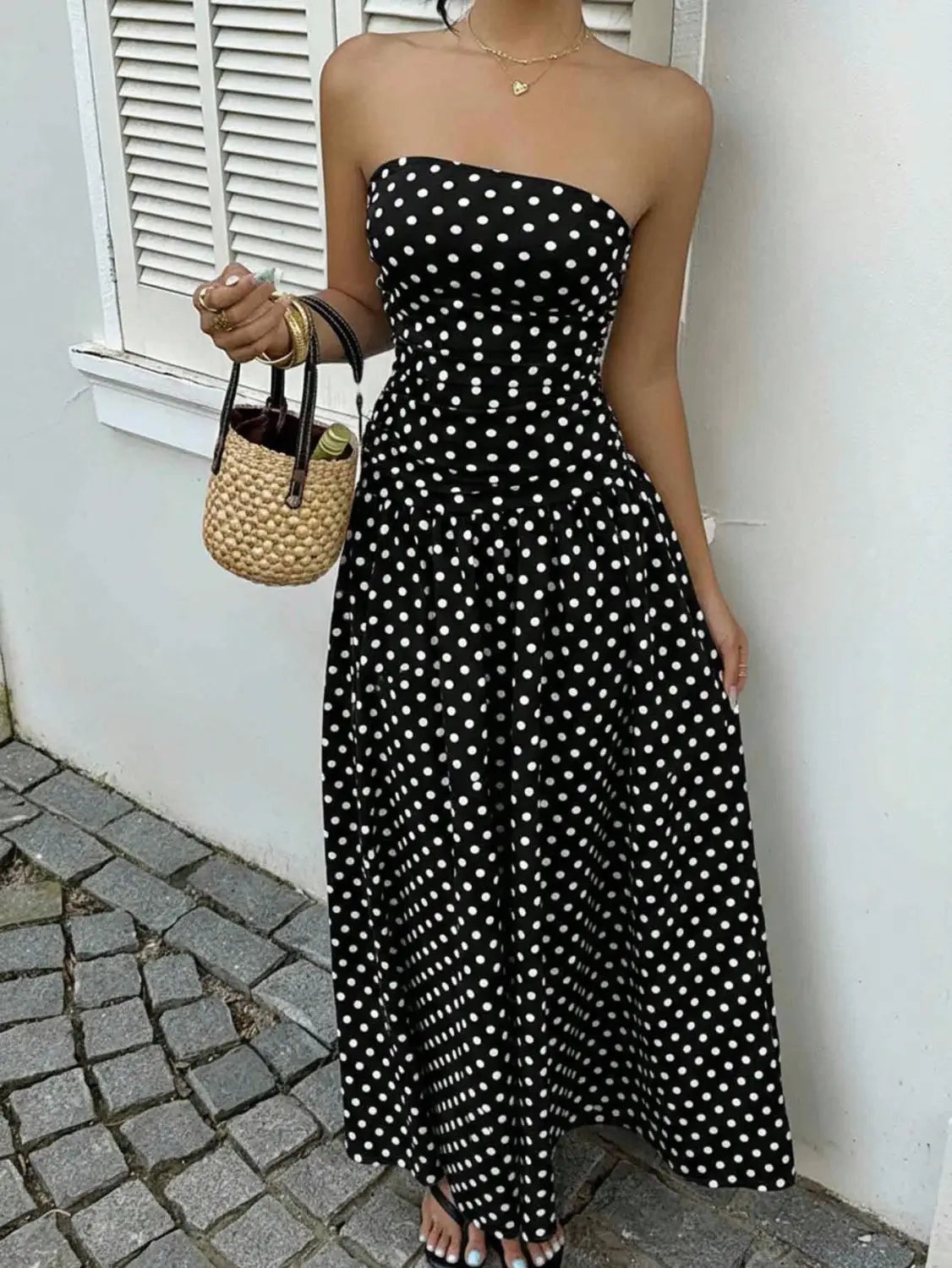 black strapless maxi dress with white polka dots featuring an off shoulder design perfect for elegant occasions