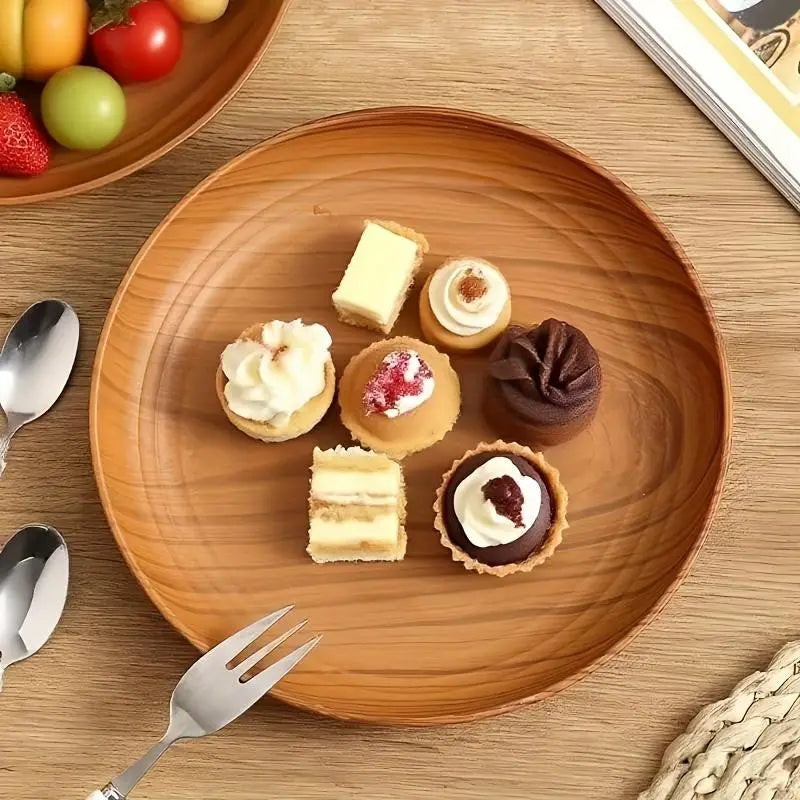 A warm-toned wood grain plastic plate with a smooth striped design holds an assortment of miniature desserts in a 10-piece round set.
