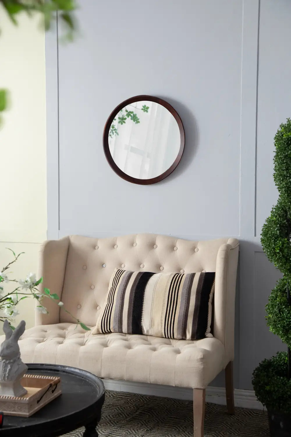 Round mirror with a dark bronze mango wood frame measuring 20 inch designed for wall mounting.