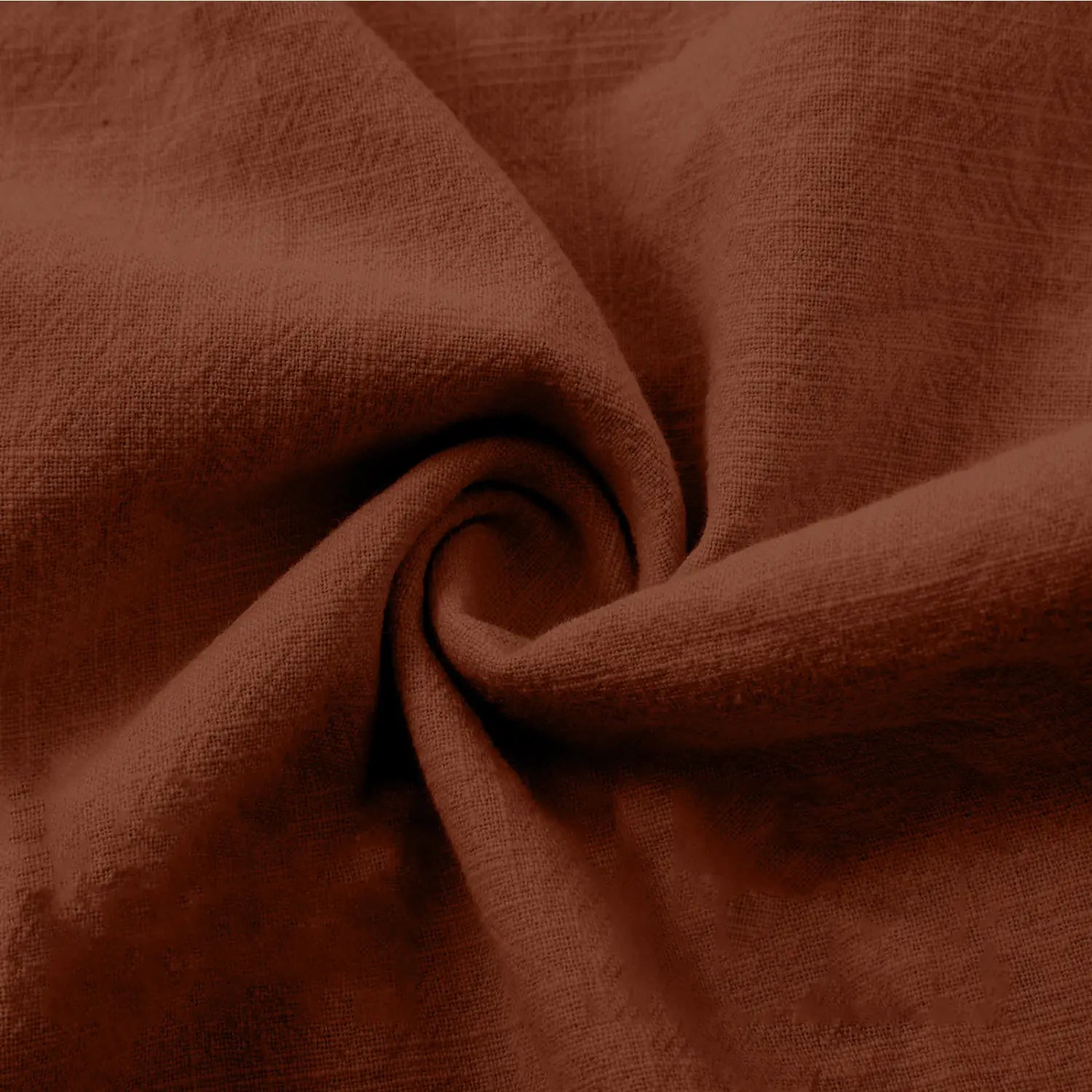 A soft rust-colored cotton linen wide leg capri trousers fabric with a subtle woven texture.