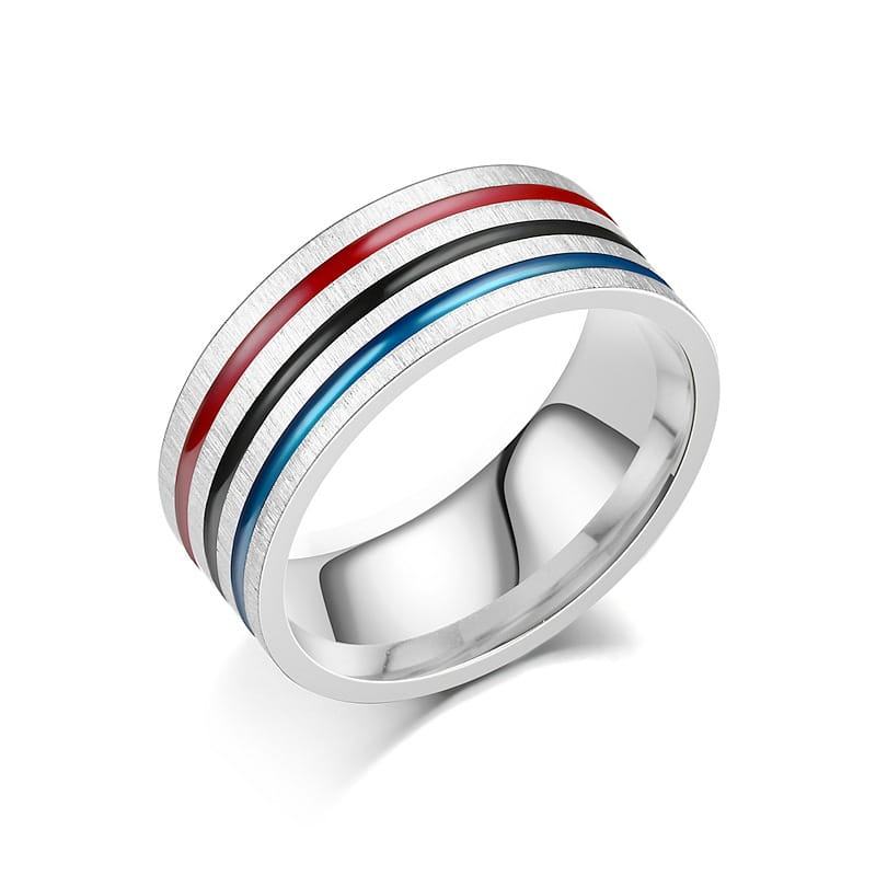 A sleek silver-toned stainless steel unisex band ring with a brushed metal finish and three vibrant red, black, and blue enamel inlaid stripes running parallel along the band.