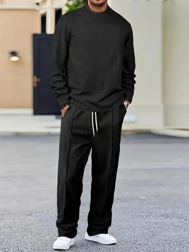 mens minimalist solid color sweatshirt jogger set featuring a black textured knit crewneck sweater with subtle pattern and ribbed cuffs