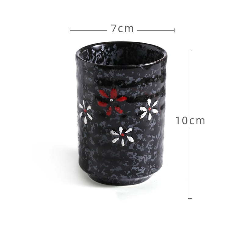 Black ceramic tea cup with a textured surface and decorative red and white floral patterns designed as a Japanese ceramic mug retro hand-painted tea cup 250ml.