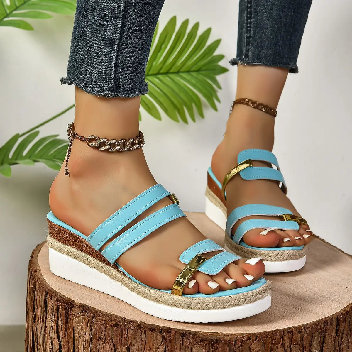 Light blue wedge sandals with espadrille jute sole and gold-tone metal accents.
