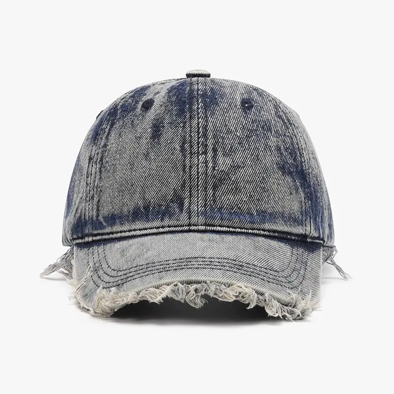 Distressed denim baseball cap with a faded gray and blue wash, frayed brim, and visible stitching.