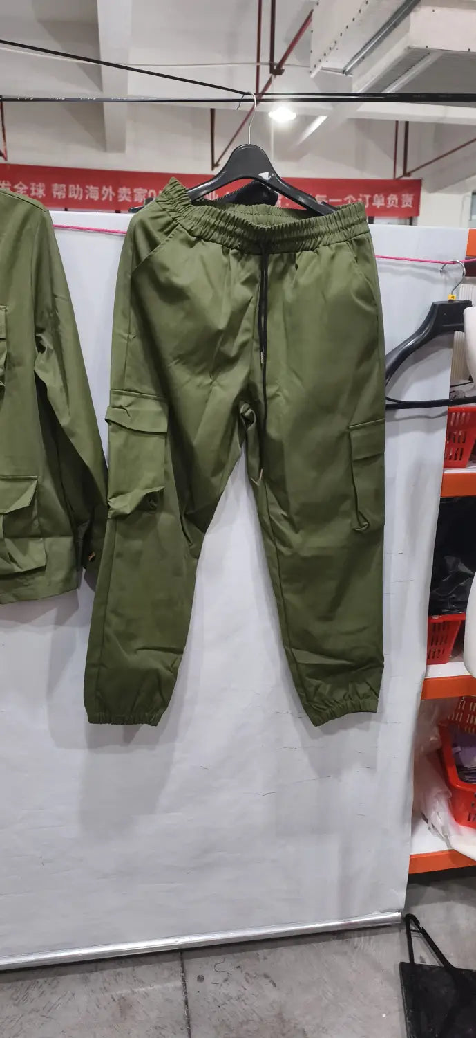 Olive green men vintage cargo pants with elastic waistband drawstring and multiple side pockets as part of a multi pocket suit.