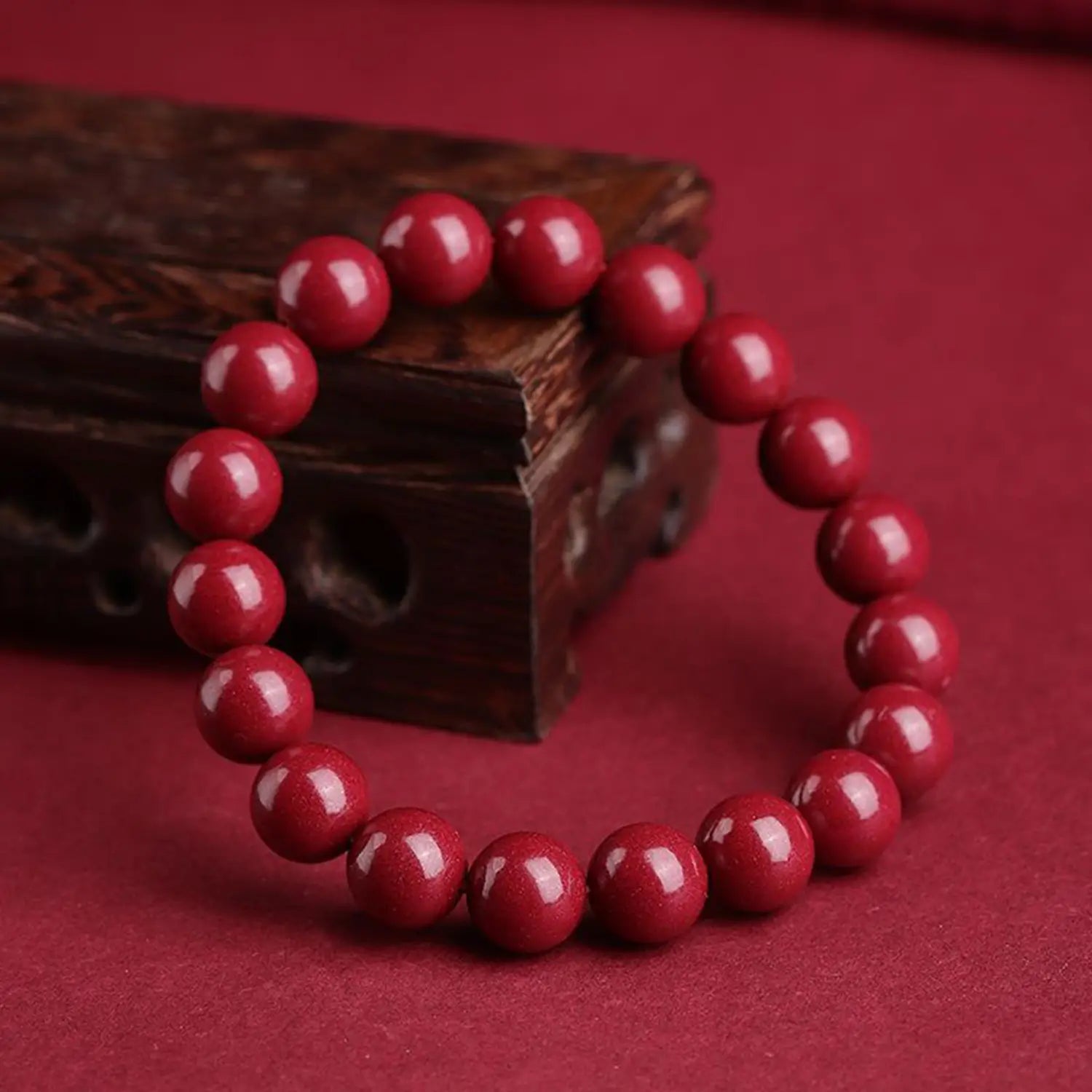 A polished red cinnabar spherical bead bracelet featuring smooth deep red uniformly sized spherical beads.
