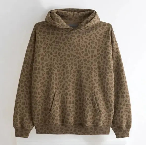 Un sweat-shirt d’hiver oversize vintage à imprimé léopard pour hommes, de couleur marron douillet, avec un tissu doux et texturé, ainsi que des poches avant classiques.