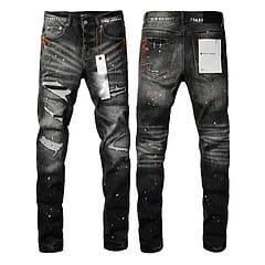 Men’s distressed slim fit black denim jeans featuring faded patches and paint splatter details.