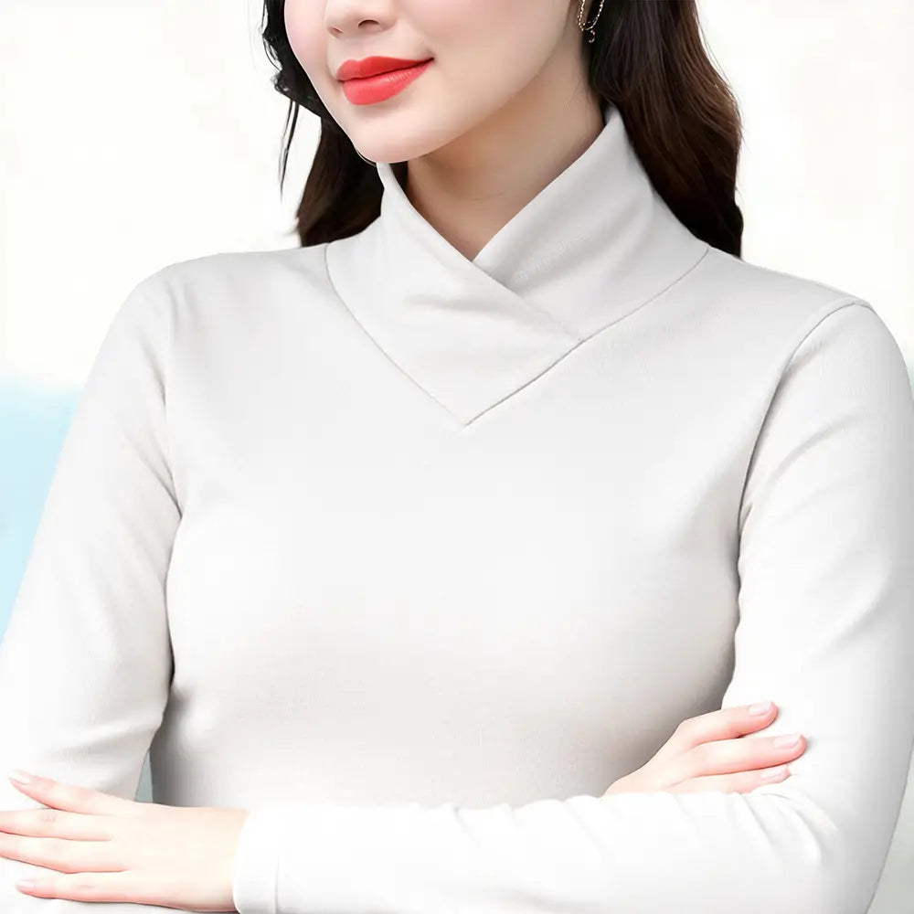 A soft off-white Dralon turtleneck thermal base layer top featuring long sleeves and a high draped collar.